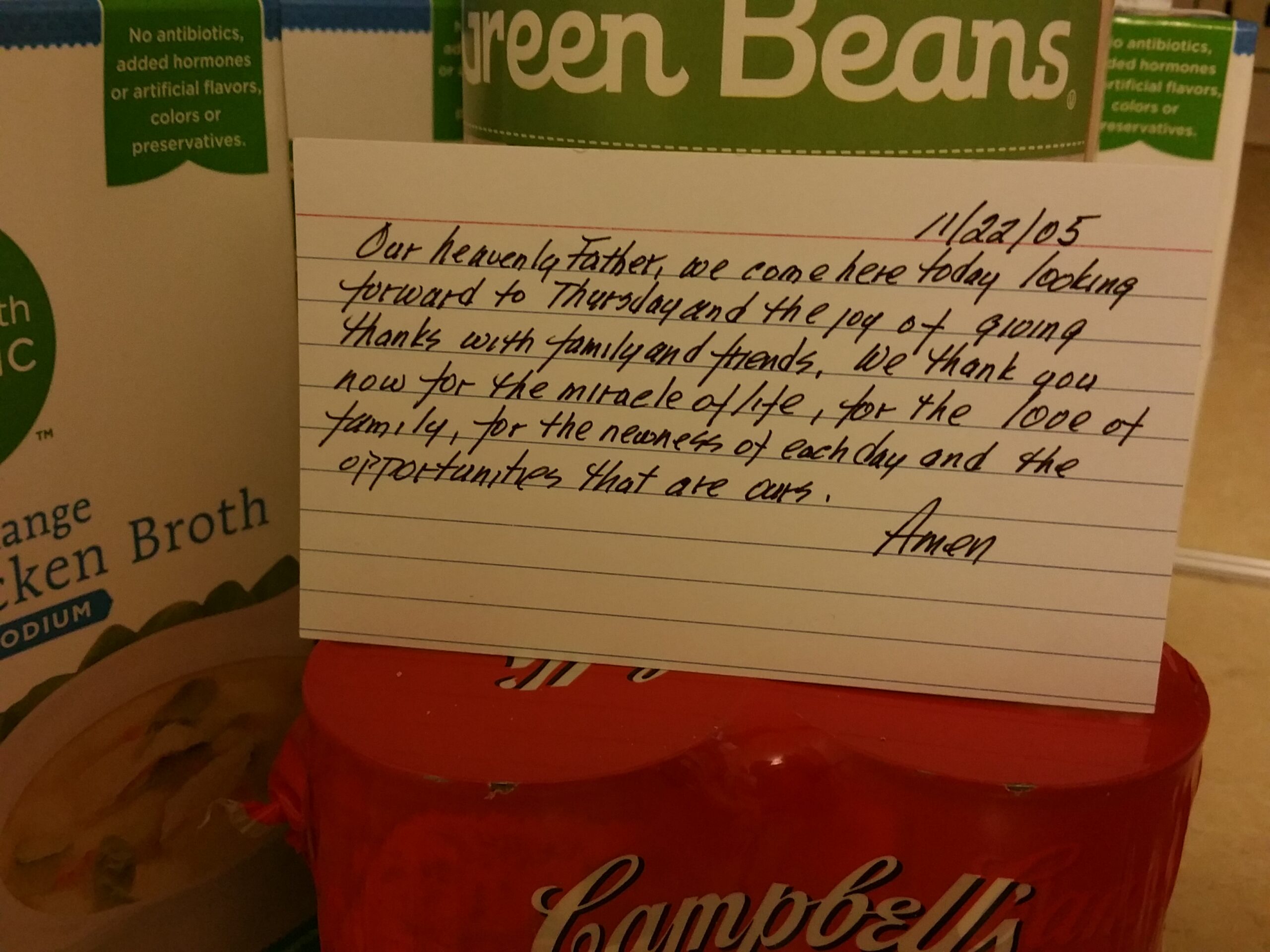 index card with a can of green beans