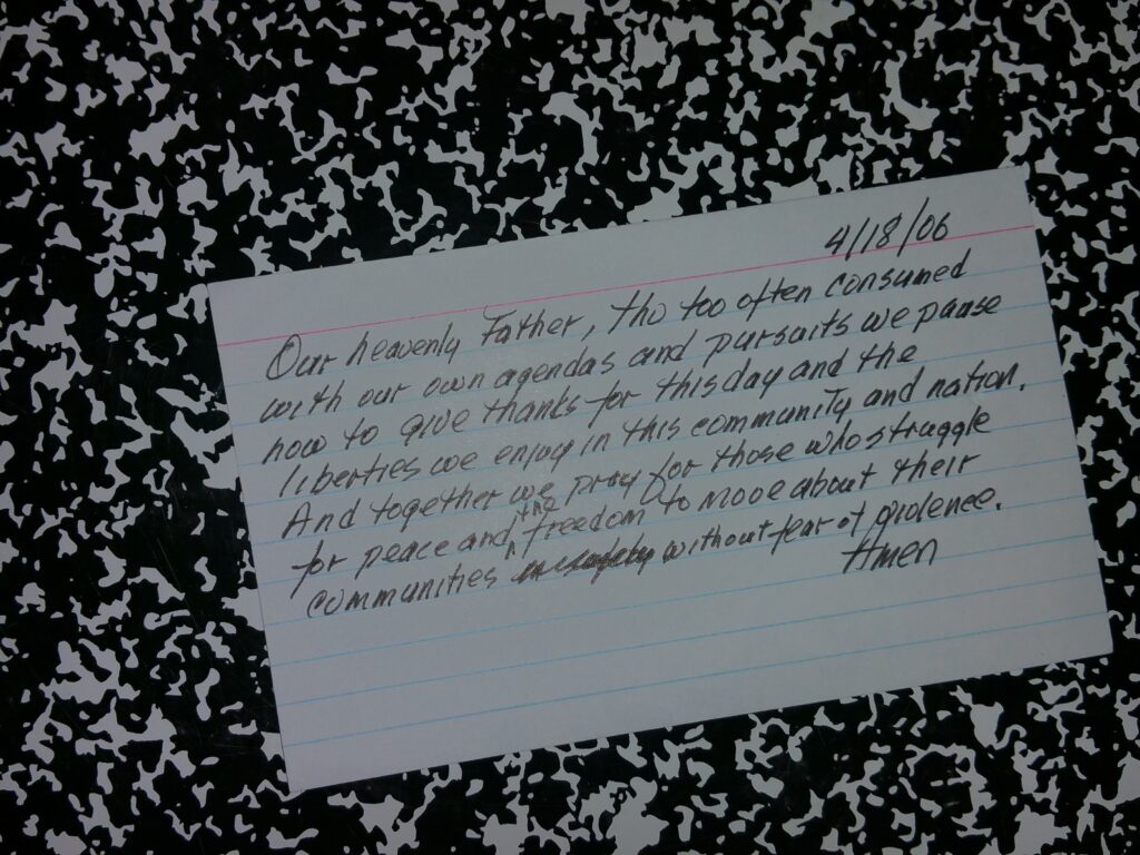 index card prayer on composition notebook