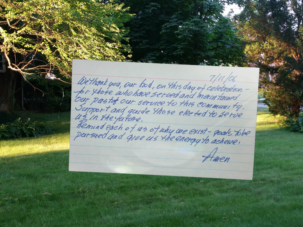 index card prayer superimposed on view out a window
