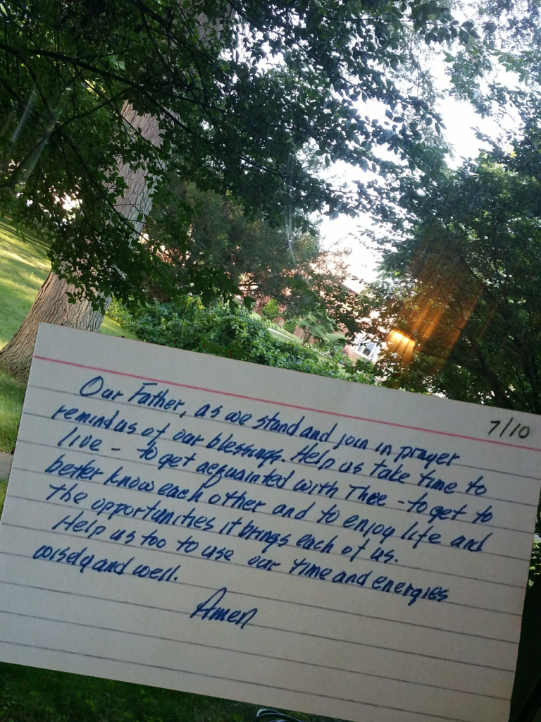 prayer on index card superimposed on view out window